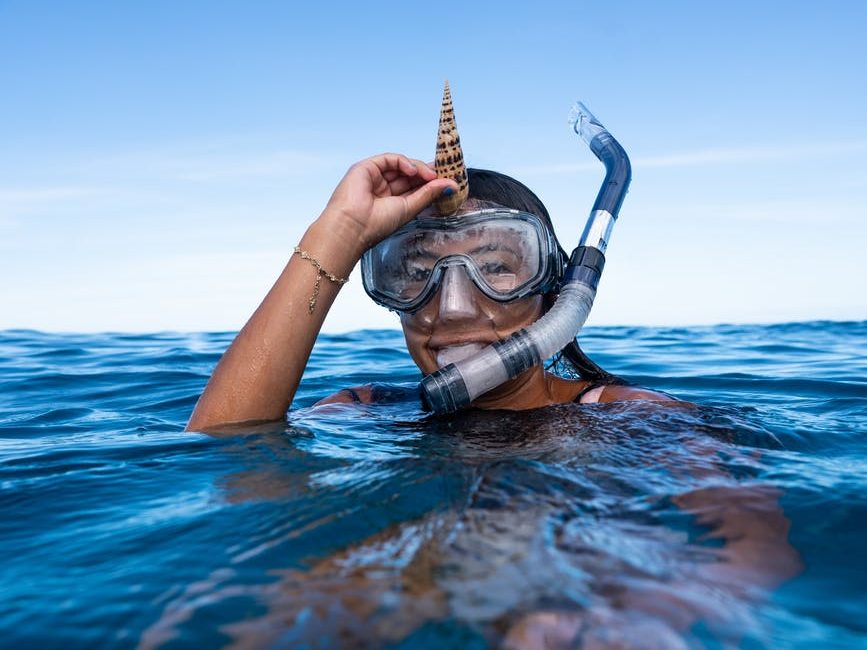 person in the water with snorkeling equipment